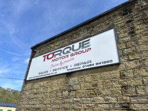Torque Motor Group showroom in Milnsbridge, Huddersfield, featuring cars and local hosts from Hudd Show Live.